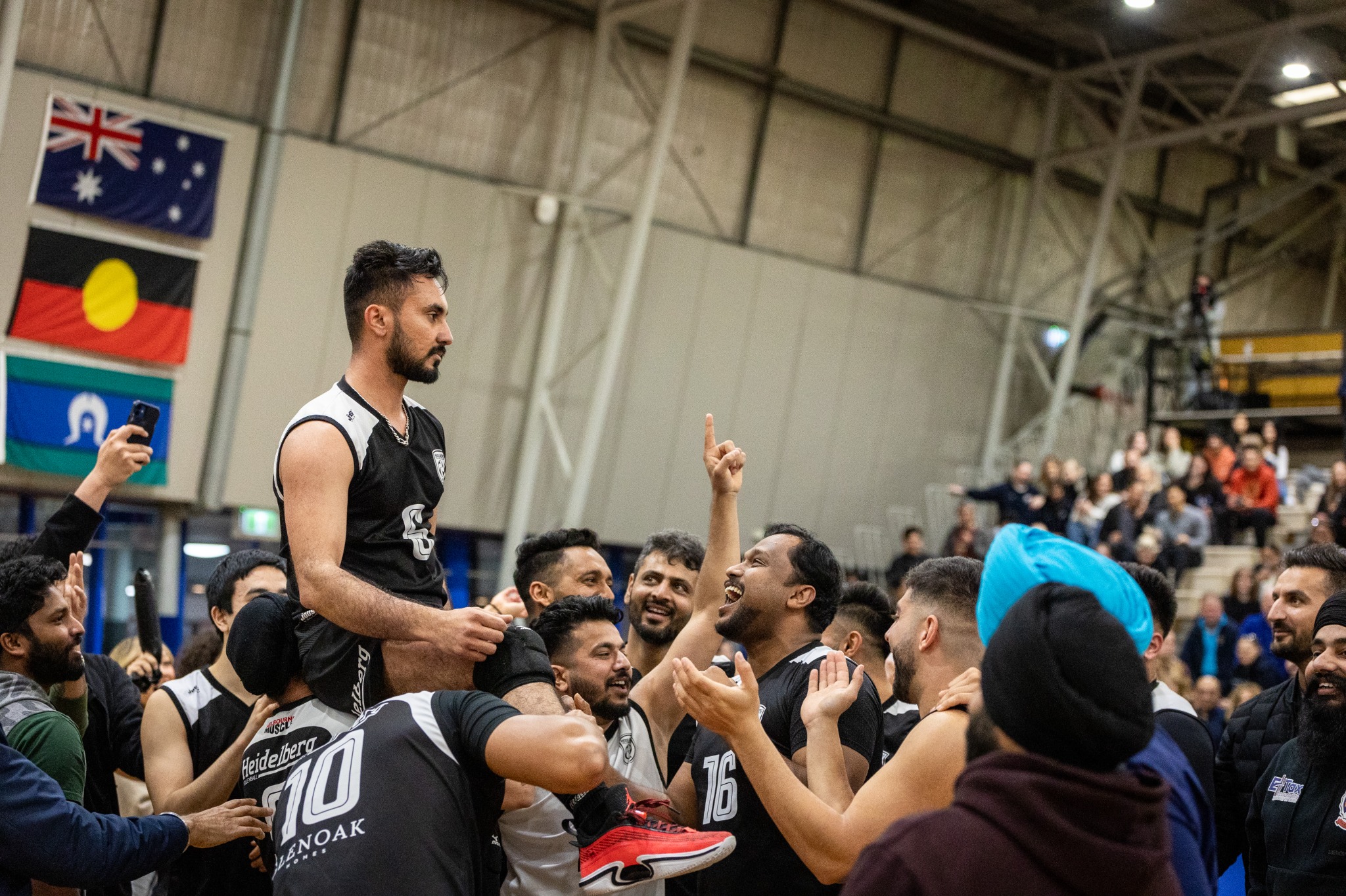 Heidelberg teammates lifting Manjot Singh after the championship win