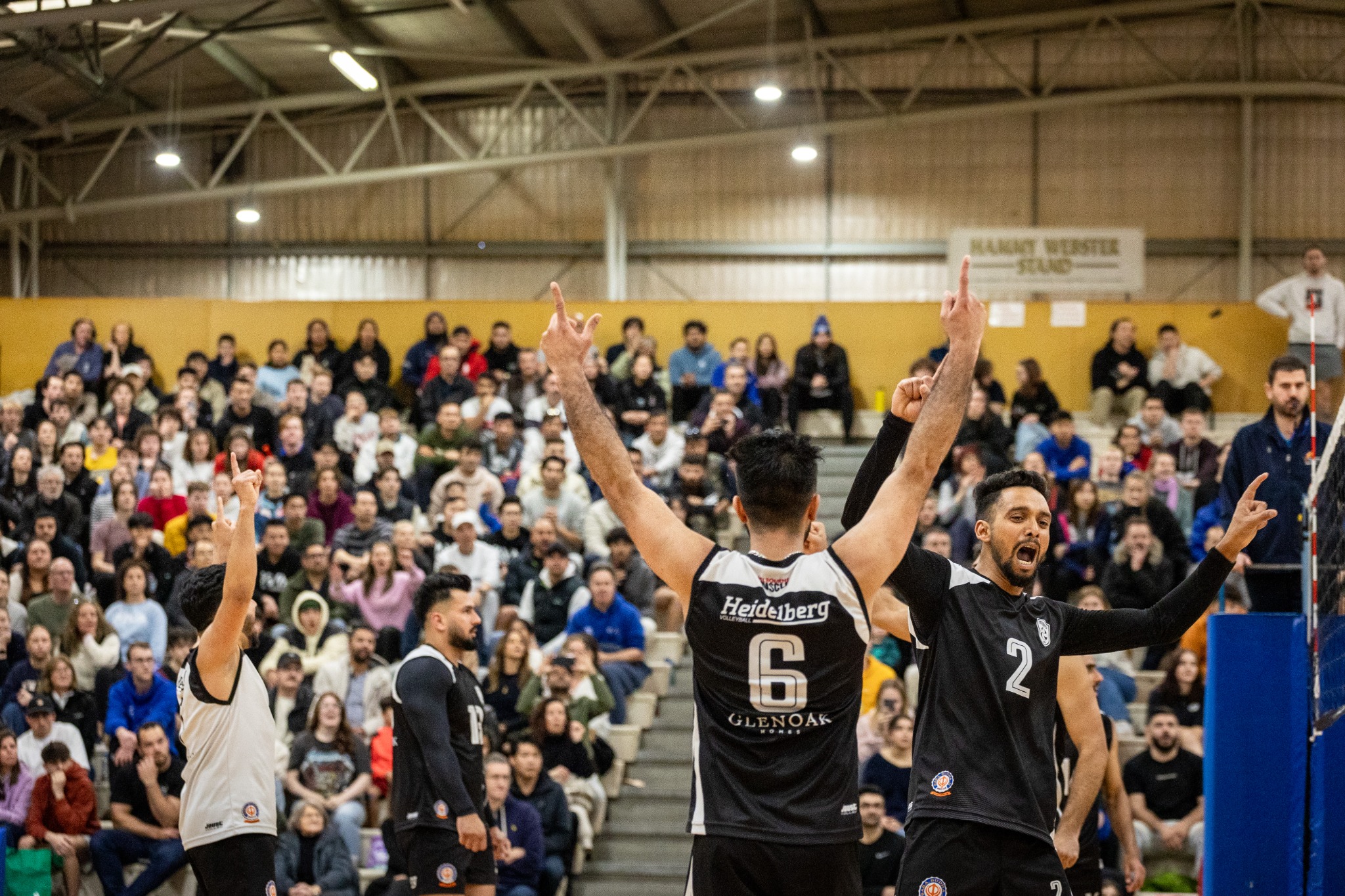 Heidelberg players celebrating a point in front of a full crowd
